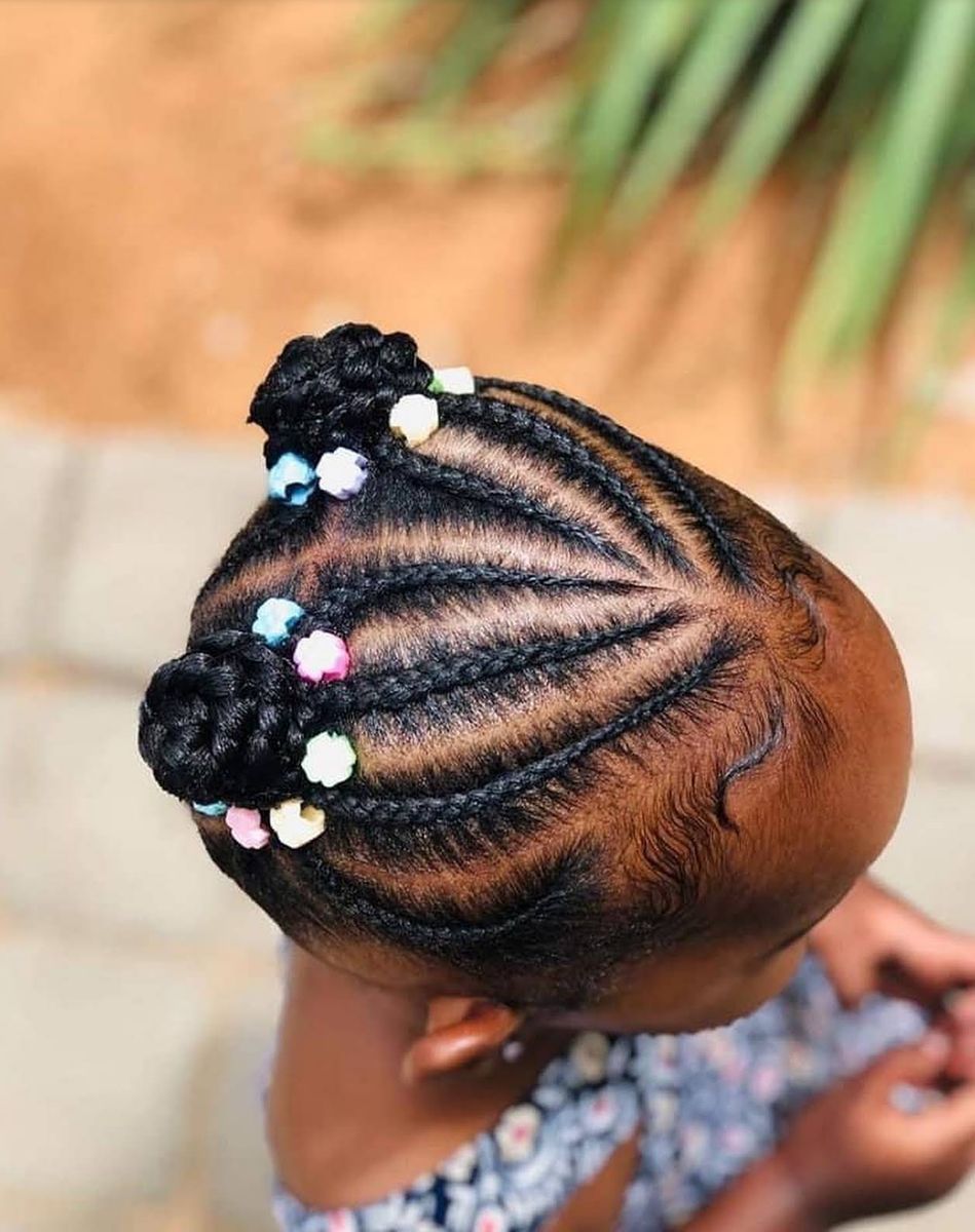 Child's cornrows in two buns with pastel beads